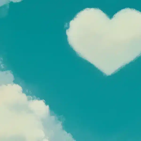 Nuage blanc en forme de cœur sur ciel turquoise avec autres nuages blancs, photographie aux tons turquoise et crème.
