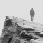 Man on stone concept photo with contemplative atmosphere